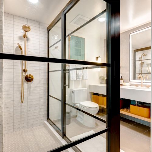 A clean, modern interior hallway with glass doors, polished floors, and warm lighting. Top it at 140 characters, always ending the sentence.